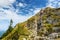 Tourists on hiking trails of picturesque Tegelberg mountain, a part of Ammergau Alps, located nead Fussen town, Germany.