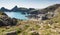 Tourists and holidaymakers walking down to the beach to enjoy late summer sunshine at Kynance Cove beach The Lizard Cornwall