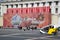 Tourists and a huge banner `Happy Victory Day` on the Palace Square in St. Petersburg.