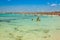 Tourists in Illetes beach Formentera island, Mediterranean sea,