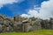 Tourists in inca ruin wall Saksaywaman, Sacred valley of Cusco, Peru