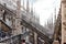 Tourists inspect fragment of decorated roof of Cathedral of Milan