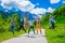 Tourists joyfully jump up against the background of snow-capped mountains.