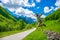 Tourists joyfully jump up against the background of snow-capped mountains.