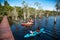Tourists kayak around wetlands to see the ancient Samet tree forest in the Botanical Garden of Rayong Province, Thailand