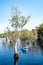 Tourists kayak around wetlands to see the ancient Samet tree forest in the Botanical Garden of Rayong Province, Thailand