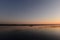 Tourists kayakers at sunset are returning from a hike on the quiet water of the lake