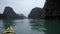 Tourists kayaking in karsts in Ha Long Bay