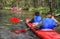 Tourists kayaking on river