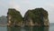 Tourists in kayaks or canoes exploring the caves and limestone islands of Ha Long Bay, Vietnam