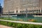 Tourists on kayaks and large tour boat on the Chicago River near floating garden bed ecosystem with native plants which serve as