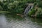 Tourists on kayaks near Roaring Threshold Waterfall on Monastyrsky Island in Dnipro Ukraine. Kayakers swim in the green water of