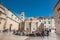 Tourists at the Large Onofrio Fountain located at Stradun street in the old town of Dubrovnik