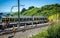 Tourists leaving the cog railway train decorated with marmots paradise sign at the Rochers de Naye mountain stop in Switzerland