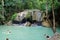 Tourists and locals in Erawan waterfalls in Kanchanaburi, Thailand.