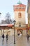 Tourists and locals spending their time near St. Florian Gate in the morning in the winter, Krakow, Poland