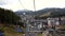 Tourists Look at the Autumn Carpathian Mountains from a Moving Ski Lift