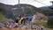 Tourists Look at the Autumn Carpathian Mountains from a Moving Ski Lift