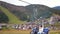 Tourists Look at the Autumn Carpathian Mountains from a Moving Ski Lift