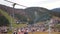 Tourists Look at the Autumn Carpathian Mountains from a Moving Ski Lift