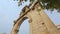 Tourists looking at Arch of Hadrian, architecture built to honor Roman emperor