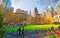 Tourists looking at Green Lawn and Skyscrapers in Bryant Park reflex