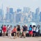 Tourists looking at the Manhattan skyline from Liberty Island