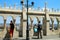 Tourists looking Parliament view through Fishermans Bastion and take pictures on the Buda Hill near old stone fence