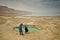 Tourists looking at sinkholes in the desert