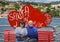 Tourists on a love bench on the shoreline of Santa Marherita Ligure, Italy