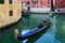 Tourists make gondola ride on canals of Venice, Italy