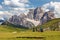 tourists on meadow mount Pelmo Alps Dolomites mountains