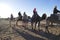 Tourists mount camels for a ride in the Sahara Desert