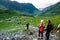 Tourists on mountain path near pass of popular tourist Transfagarasan road, one of most beautiful roads in world. Top view of
