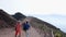 Tourists moving along walkway around Vesuvius volcano, passing its sharp cliffs