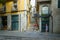 Tourists are on narrow street in historic center of Girona, Spain