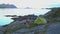 Tourists near a tent on the shore of the fjord