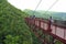 Tourists on observation deck look down into deep gorge.