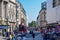 Tourists, Old Buildings and Scaffolding in London Street on a Sunny Summer Day