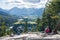 Tourists overlooking the Town of Banff from Tunnel Mountain Trail summit in summer sunny day. Banff National Park