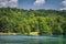 Tourists paddling in two paddleboats on lake in Plitvice Lakes