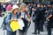 Tourists pass next to Police controls the access to international Sants rails station in Barcelona