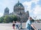 Tourists pass on street outside historic Berlin Cathedral on one end Museum Island example of Baroque architecture