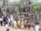 Tourists and performers inside Bayon Temple at Angkor in Cambodia