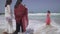 Tourists are photographed on the background of the Persian Gulf on the Public Jumeirah Open Beach, Dubai