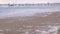 Tourists are photographed on the pier in the sea. Storm on the sea with big waves. Beautiful seascape at sunset.