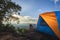 Tourists pitch a tent on the cliff