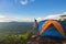 Tourists pitch a tent on the cliff