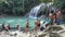 Tourists playing in the water at Erawan waterfall in Kanchanaburi, Thailand. Beautifu
