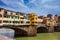 Tourists at Ponte Vecchio a medieval stone closed-spandrel segmental arch bridge over the Arno